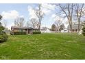 Expansive backyard with lush lawn and mature trees, offering plenty of space at 89 E Walnut St, Fountaintown, IN 46130