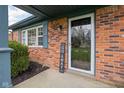 Close-up of the front porch highlighting the brickwork and charming decor at 89 E Walnut St, Fountaintown, IN 46130