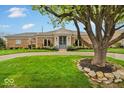 Beautiful single-story brick home featuring a lush green lawn and mature shade tree at 958 Tamarack Cir N Dr, Indianapolis, IN 46260