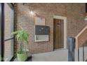 Common mail area with mailboxes, a corkboard, and a potted plant, featuring brick walls at 102 Knoll Ct # D, Noblesville, IN 46062