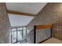 View from a staircase landing showcasing a brick wall and a sunlit entrance at 102 Knoll Ct # D, Noblesville, IN 46062