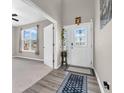 Bright entryway featuring wood-look floors and a decorative glass front door at 1075 Barberry Dr, Greenwood, IN 46143