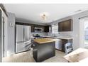 Modern kitchen featuring stainless steel appliances, a butcher block island, and ample cabinet space at 11741 Langham Crescent Ct, Fishers, IN 46037