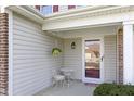 Cozy front porch with a small table set, perfect for enjoying the outdoors at 11741 Langham Crescent Ct, Fishers, IN 46037
