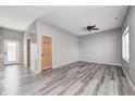 Spacious living area featuring wood floors, gray walls, two doors, and a ceiling fan at 11975 Civic Cir, Mooresville, IN 46158