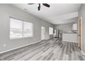 Open-concept living area with wood floors, gray walls, modern appliances, and lots of natural light at 11975 Civic Cir, Mooresville, IN 46158