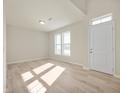 Bright living room showcasing wood floors, a large window, and a neutral color palette at 12009 Jeff Ct, Noblesville, IN 46060