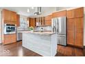 Modern kitchen with stainless steel appliances, island, and stylish cabinets at 12527 Saksons Blvd, Fishers, IN 46038