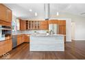 Bright kitchen with island, stainless appliances, and attractive hardwood floors at 12527 Saksons Blvd, Fishers, IN 46038