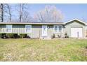 Charming single-story home featuring a well-kept lawn and simple landscaping with a single car garage at 12566 S Hillview Dr, Columbus, IN 47201