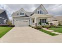 Two-story craftsman home boasting an attached two-car garage and cozy front porch at 1472 Windpump Way, Carmel, IN 46280