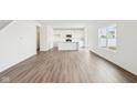 Open-concept living room featuring hardwood floors and white walls at 1554 N Clearwater Dr, Greenfield, IN 46140