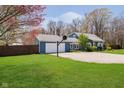 Beautiful blue single-story home featuring an attached garage and spacious yard at 16471 E 196Th St, Noblesville, IN 46060