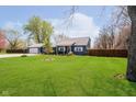Captivating view of a blue single-story home with a lush green lawn and mature trees at 16471 E 196Th St, Noblesville, IN 46060