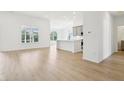 Bright, open-concept living room and kitchen featuring hardwood floors and lots of natural light at 19245 Red Willow Ln, Noblesville, IN 46062