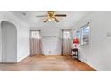 An airy living room features hardwood floors, a ceiling fan, and white walls at 2035 Koehne St, Indianapolis, IN 46202
