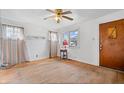 A bright living room with hardwood floors, natural light, and a ceiling fan at 2035 Koehne St, Indianapolis, IN 46202