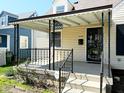 Inviting front porch with covered awning, decorative railings, and a clear view of the home's entrance at 2050 Winton Ave, Indianapolis, IN 46224