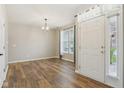 Bright living room featuring wood flooring, neutral walls, and a white front door at 2236 Willowview Dr, Indianapolis, IN 46239