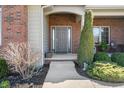 Charming front porch with a brick facade, decorative plants, and an inviting entrance at 267 Westbrook Ct, Columbus, IN 47201