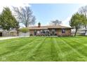 Attractive single-story brick home featuring a lush green lawn and mature trees at 3607 Windsor Way, Anderson, IN 46011