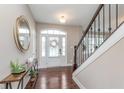 Inviting foyer with hardwood floors, staircase, and decorative mirror at 3728 Dunellen Cir, Carmel, IN 46074