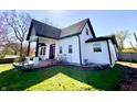 Charming home with black trim, bay window, white siding, landscaping, and a green lawn at 4029 W Fairview Rd, Greenwood, IN 46142
