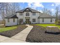 Beautiful exterior of a white brick home with a winding walkway and manicured lawn at 4312 S Woodbridge Ln, New Palestine, IN 46163