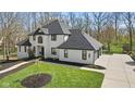Aerial view of a two-story home with a manicured lawn and attached two-car garage at 4312 S Woodbridge Ln, New Palestine, IN 46163