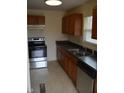 Kitchen features stainless steel appliances, wood cabinets, and a double stainless steel sink at 4431 Bertrand Rd, Indianapolis, IN 46222