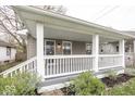 Inviting front porch with classic white railings and posts at 4742 Primrose Ave, Indianapolis, IN 46205