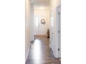 Bright entryway with modern decor, a white door, and wood-look flooring at 5301 Tanglewood Ln, Whitestown, IN 46075
