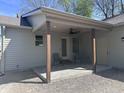 Relaxing outdoor patio with ceiling fan, seating, and access to the home's exterior at 609 W Pearl St, Trafalgar, IN 46181