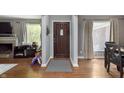 Inviting entryway with hardwood floors, a decorative front door, and views into living and dining areas at 7026 Spring Mill Rd, Indianapolis, IN 46260