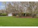 Traditional brick home with lush green lawn and mature trees offering shade and curb appeal at 7026 Spring Mill Rd, Indianapolis, IN 46260