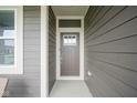 Close-up of the brown front door with sidelight at 714 Faudree Dr, Westfield, IN 46074