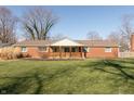 Attractive single-story brick home with a welcoming covered porch and green lawn at 7260 Marla Dr, Indianapolis, IN 46256