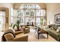 Bright living room with large windows, neutral decor, comfortable seating, and hardwood furniture at 8037 Lynch Ln, Indianapolis, IN 46250