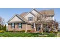 Beautiful home showcasing a lush green lawn and mature trees, adding to its curb appeal and natural setting at 8855 Sugar Cay Ct, Zionsville, IN 46077
