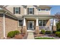 Welcoming front entrance with brick accents, decorative columns, and a cozy porch, enhancing curb appeal at 8855 Sugar Cay Ct, Zionsville, IN 46077