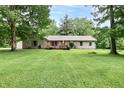 Charming one-story home with brick accents, a spacious yard, and mature trees at 1000 Janet Dr, Greenwood, IN 46142