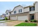Charming townhome showcasing attached garages, green grass and well-maintained landscaping at 1012 S Montgomery Rd, Greenwood, IN 46143
