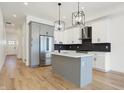 A modern kitchen featuring an island, stainless steel appliances, and stylish pendant lighting at 1018 Calvary St, Indianapolis, IN 46203