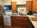 Traditional eat-in kitchen with stainless steel appliances and light-colored wood cabinetry at 1018 E 106Th St, Indianapolis, IN 46280