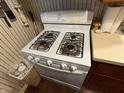 Close-up of the white, four-burner Amana gas stove at 1018 E 106Th St, Indianapolis, IN 46280