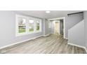 Bright, open-concept living room with hardwood floors and large windows at 121 Illinois St, Shirley, IN 47384