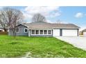 Charming home featuring an attached two-car garage, perfect for suburban living at 1254 E 400 N, Greenfield, IN 46140
