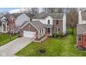 Aerial view of a two-story home with brick accents, a spacious yard, and an attached garage at 12753 Bristow Ln, Fishers, IN 46037