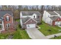 An aerial view showcasing the home, its driveway, and well-kept surrounding landscape and neighboring houses at 12753 Bristow Ln, Fishers, IN 46037