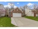 Beautiful home featuring a well-manicured lawn, two-car garage, and neutral color palette at 12753 Bristow Ln, Fishers, IN 46037